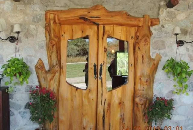 Puerta doble tallada en troncos
